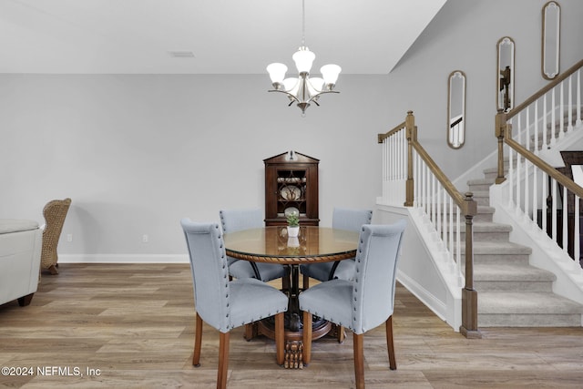 dining area featuring a chandelier and light hardwood / wood-style flooring