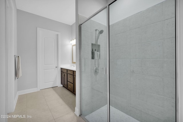 bathroom with vanity, an enclosed shower, and tile patterned floors