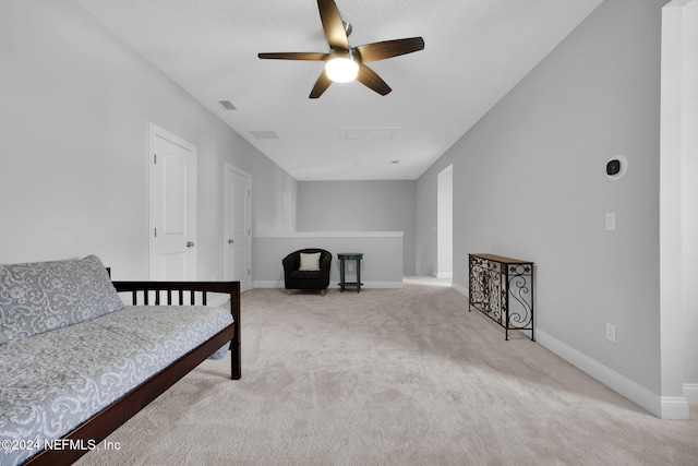 interior space featuring light carpet and ceiling fan