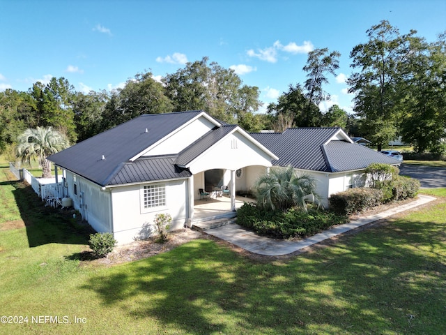 view of front facade with a patio and a front yard