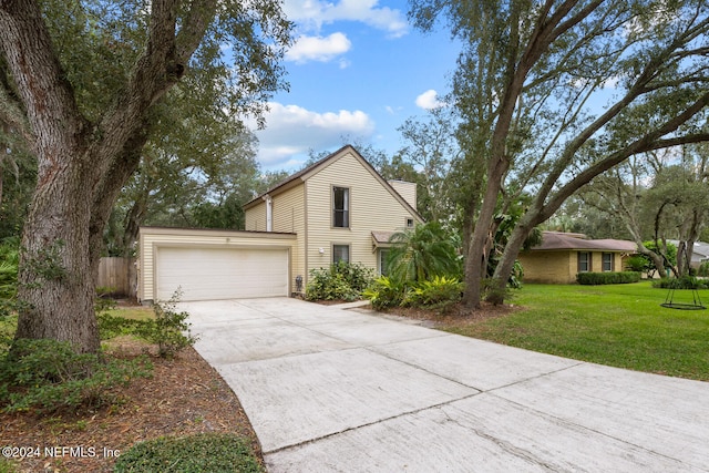 view of front of house with a garage and a front lawn