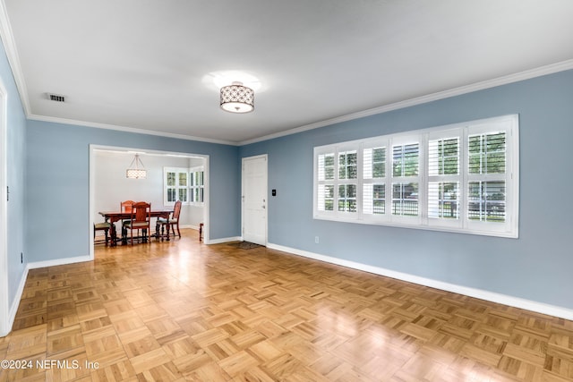 spare room featuring ornamental molding and light parquet floors