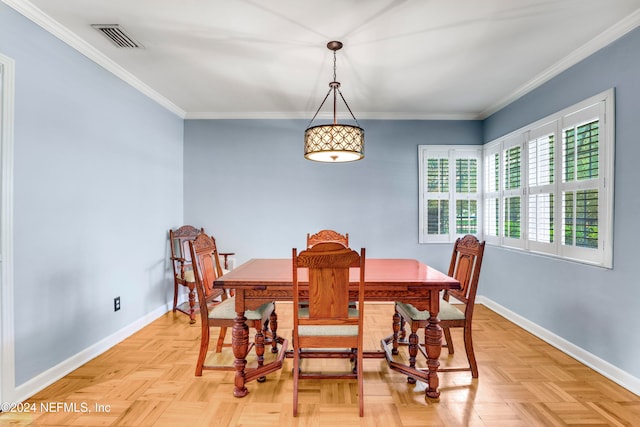 dining room with ornamental molding and light parquet floors