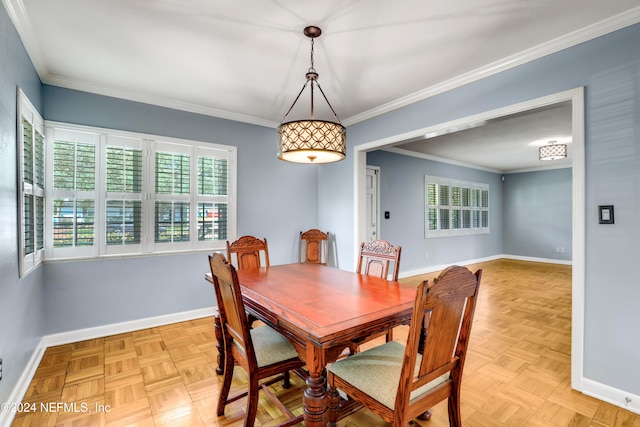 dining room featuring crown molding and light parquet flooring