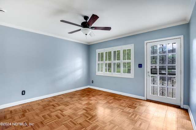 empty room featuring light parquet floors, ornamental molding, and ceiling fan