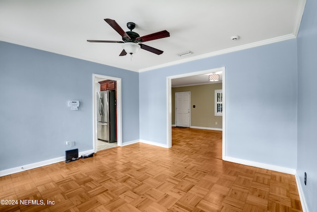 empty room with ceiling fan, light parquet flooring, and crown molding