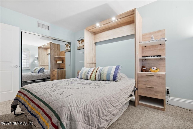 bedroom with light colored carpet and a closet