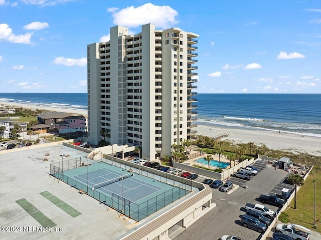 bird's eye view featuring a water view and a beach view