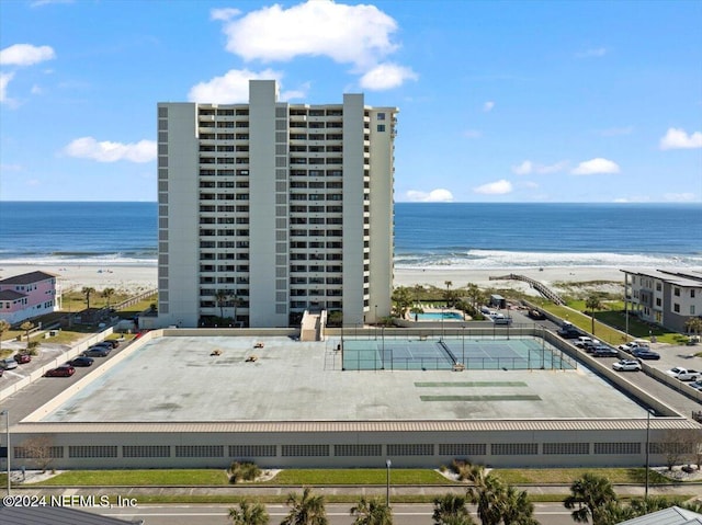 birds eye view of property with a water view and a beach view