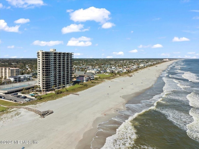 birds eye view of property featuring a beach view and a water view