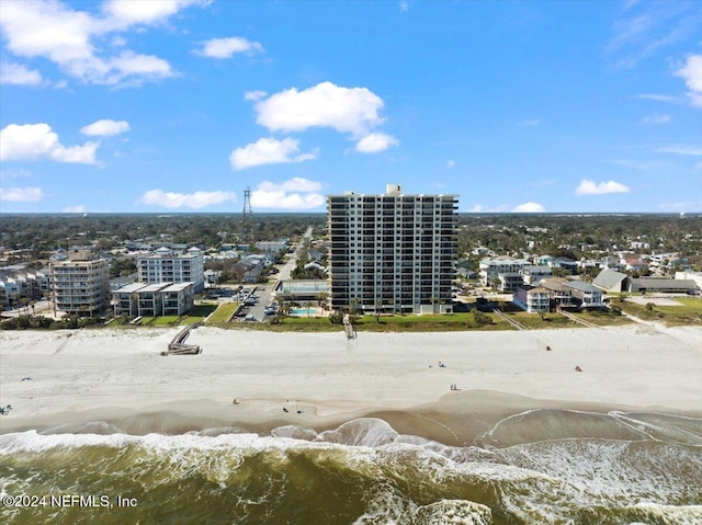 birds eye view of property featuring a water view and a beach view