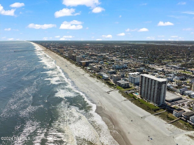 bird's eye view with a water view and a beach view