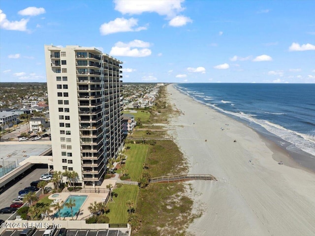 birds eye view of property featuring a view of the beach and a water view