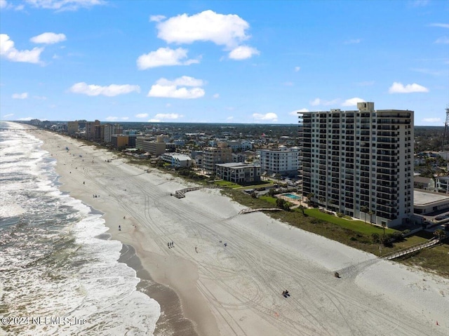 birds eye view of property featuring a beach view and a water view