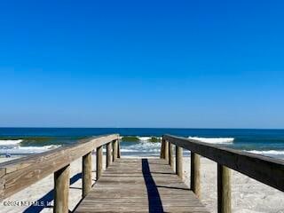 dock area with a water view and a view of the beach