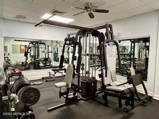 workout area with ceiling fan and a paneled ceiling