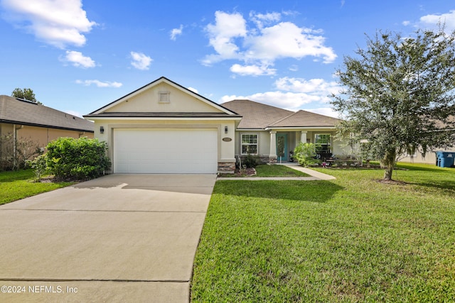 single story home with a garage and a front lawn