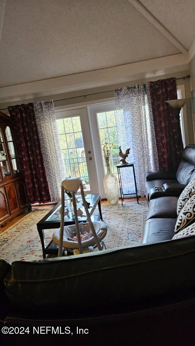 living room with lofted ceiling and a textured ceiling