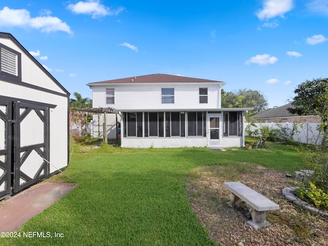 back of property featuring a shed, a sunroom, and a lawn