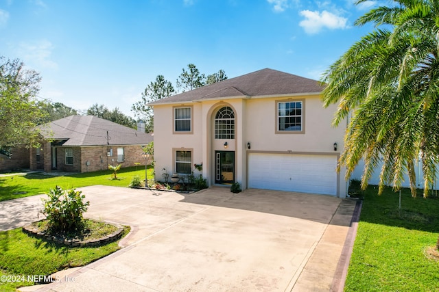 view of front of house with a garage and a front lawn