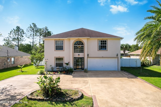 view of front of home with a front lawn and a garage