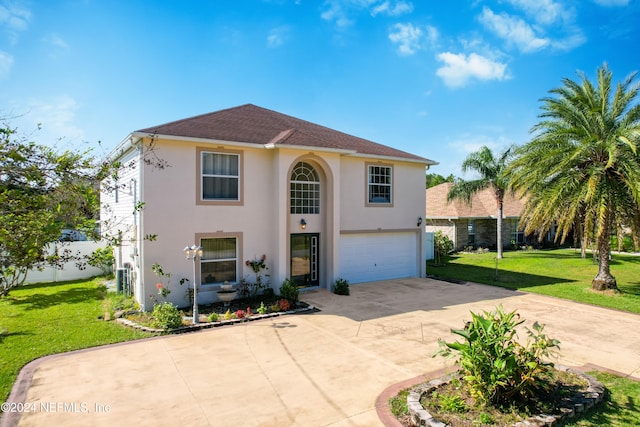 mediterranean / spanish home with a front lawn and a garage