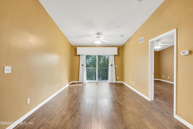 unfurnished room with ceiling fan, wood-type flooring, a textured ceiling, and lofted ceiling