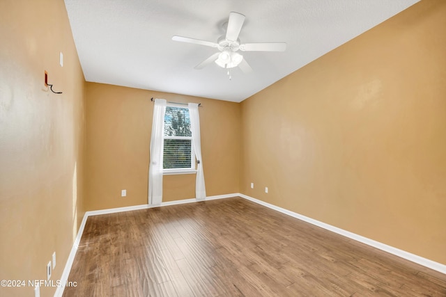 empty room featuring hardwood / wood-style flooring and ceiling fan