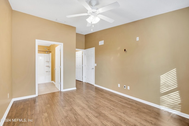 unfurnished bedroom featuring connected bathroom, ceiling fan, and light hardwood / wood-style floors