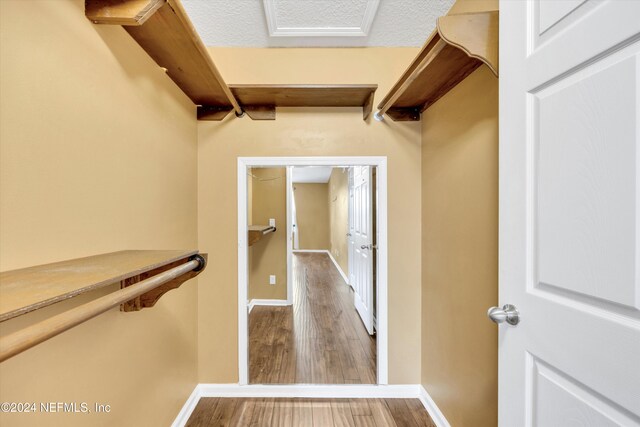 spacious closet featuring hardwood / wood-style floors