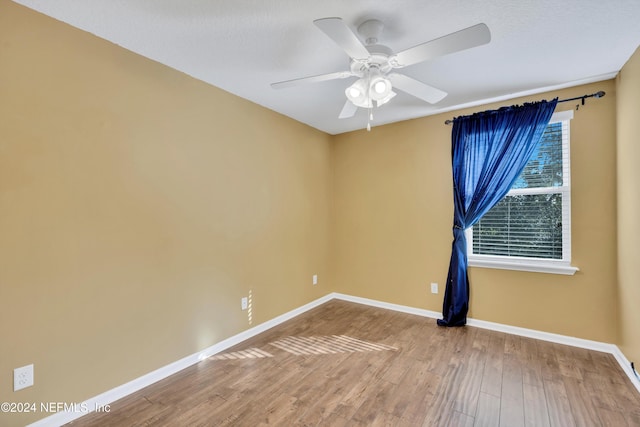 unfurnished room featuring ceiling fan, wood-type flooring, and a textured ceiling