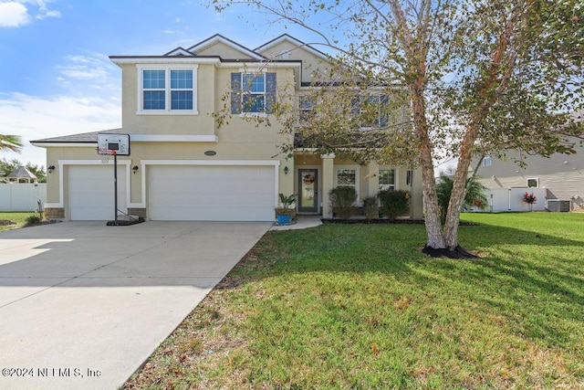 front of property with a garage, central AC, and a front lawn