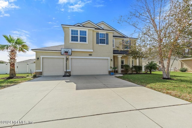 view of front of home featuring a garage and a front lawn