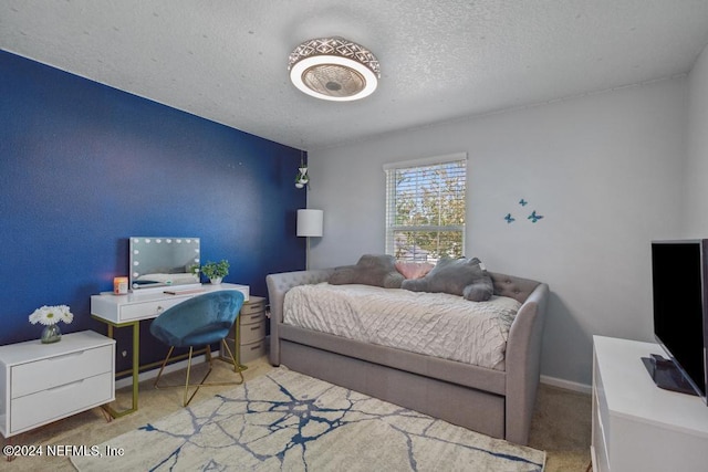 bedroom with a textured ceiling and carpet