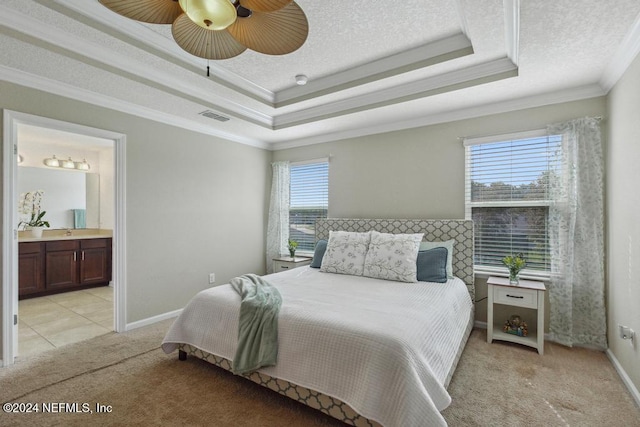 bedroom with multiple windows, light carpet, ceiling fan, and connected bathroom