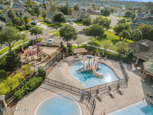 view of pool with a playground and a water slide