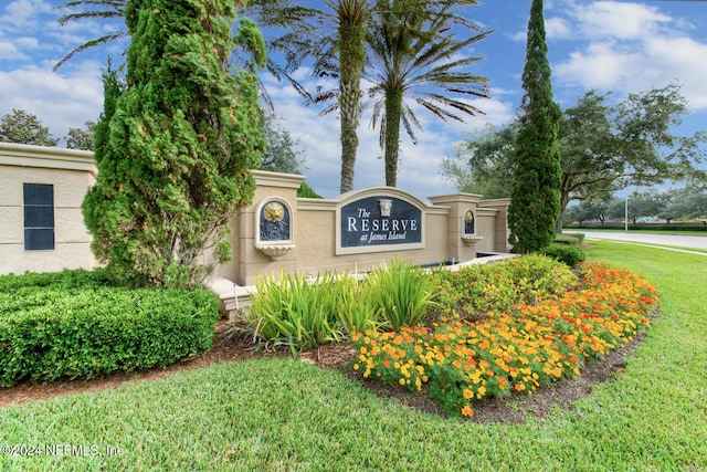 community / neighborhood sign with a lawn