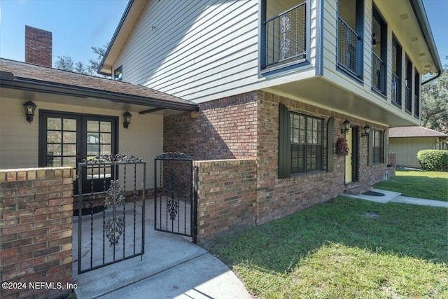 view of side of home with a yard