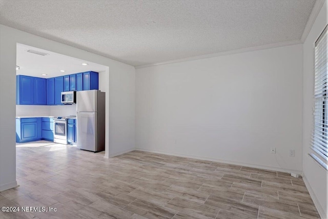 kitchen with blue cabinetry, appliances with stainless steel finishes, a textured ceiling, and crown molding