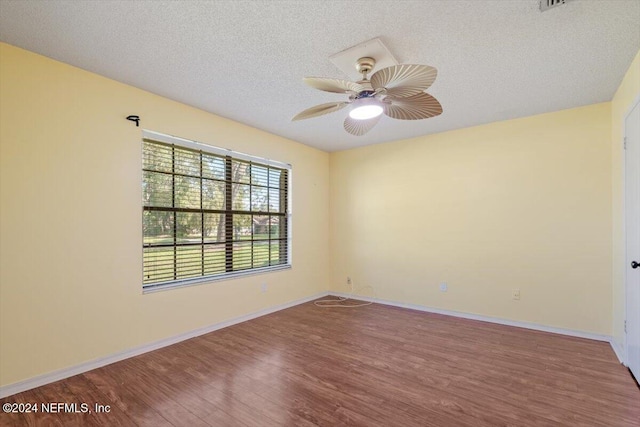 spare room with a textured ceiling, hardwood / wood-style flooring, and ceiling fan