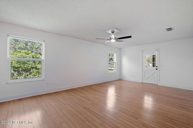 spare room featuring ceiling fan, a textured ceiling, and light hardwood / wood-style floors