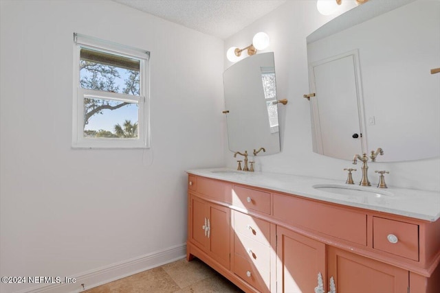 bathroom featuring vanity and a textured ceiling