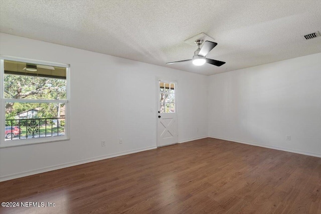 unfurnished room with dark wood-type flooring, a textured ceiling, and ceiling fan