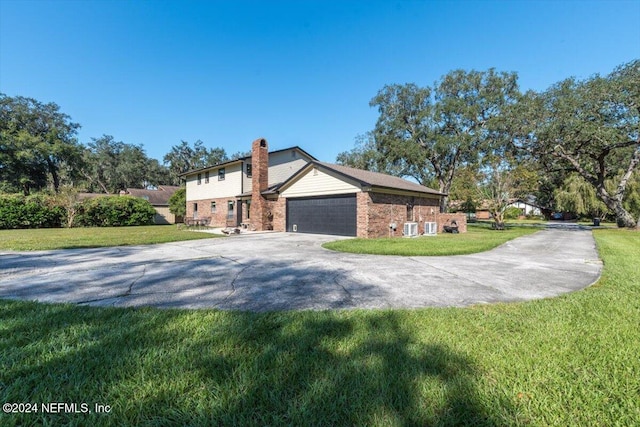 view of side of property featuring a lawn and a garage