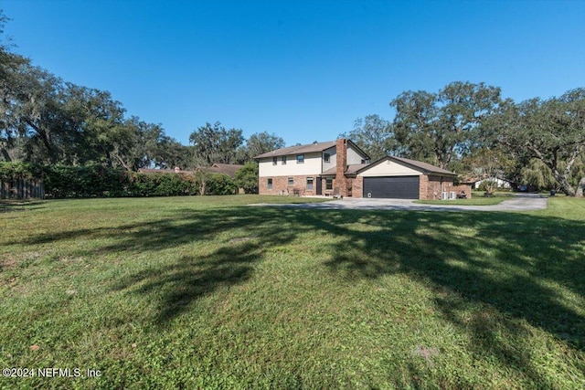 view of front of house featuring a garage and a front yard