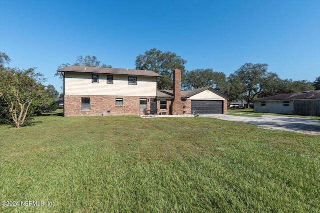 view of front of property with an outbuilding, a front yard, and a garage