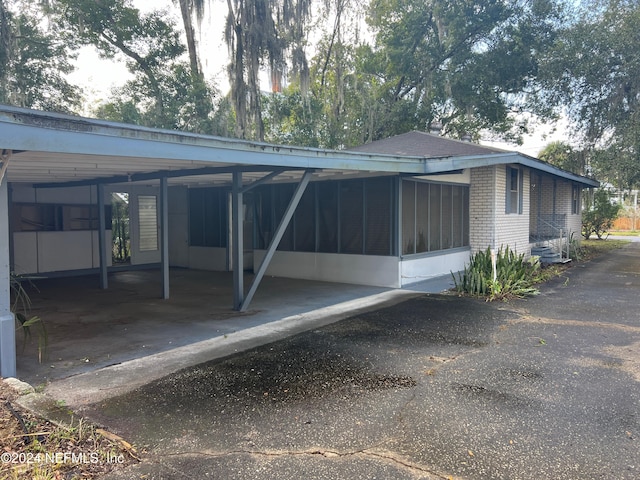 back of house featuring a sunroom