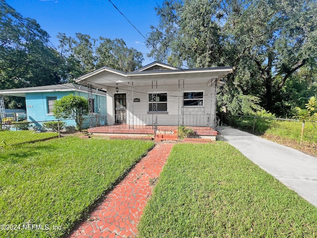 view of front of house featuring a front yard and covered porch