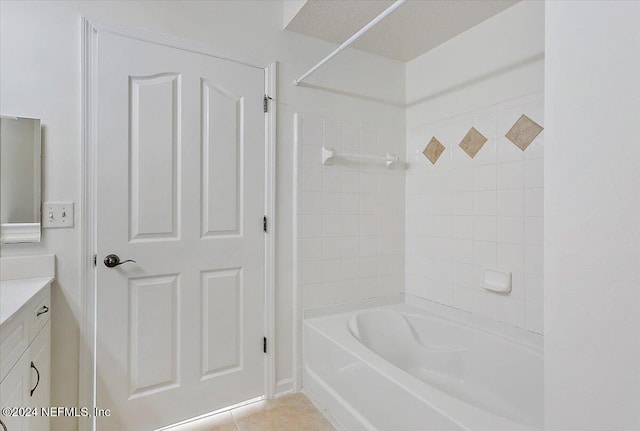 bathroom featuring vanity, tiled shower / bath combo, and tile patterned floors