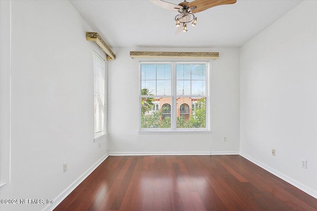 spare room featuring ceiling fan and dark hardwood / wood-style flooring